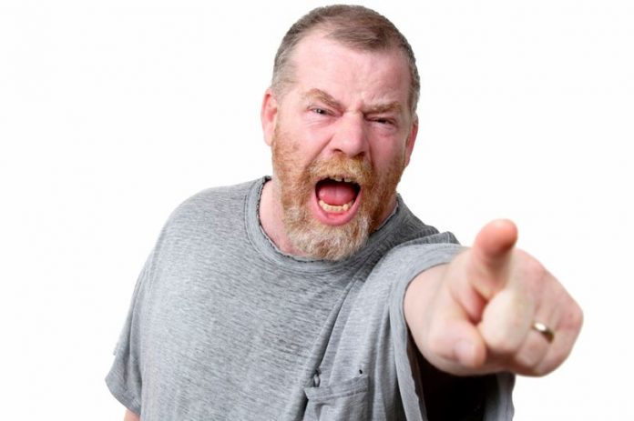 Angry-man-shouting-and-pointing-to-camera-studio-shot-696x463