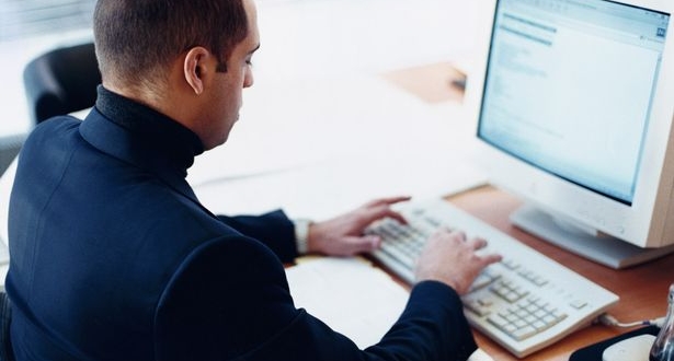 Man-working-at-a-computer-615x330
